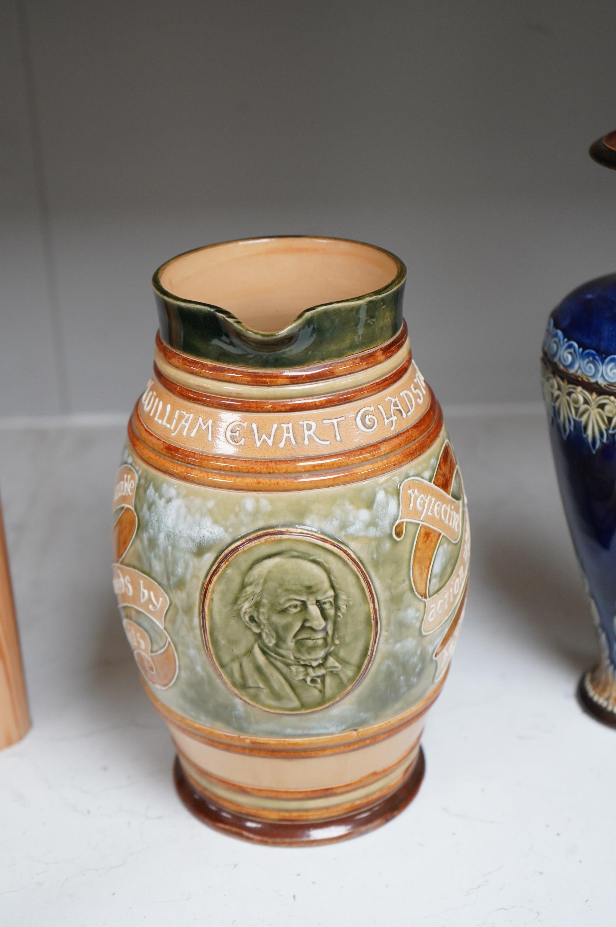 A Doulton Lambeth stoneware commemorative pitcher of William Ewart Gladstone 23cm high, together with a pair of vases two handled vase and a mug, (5).